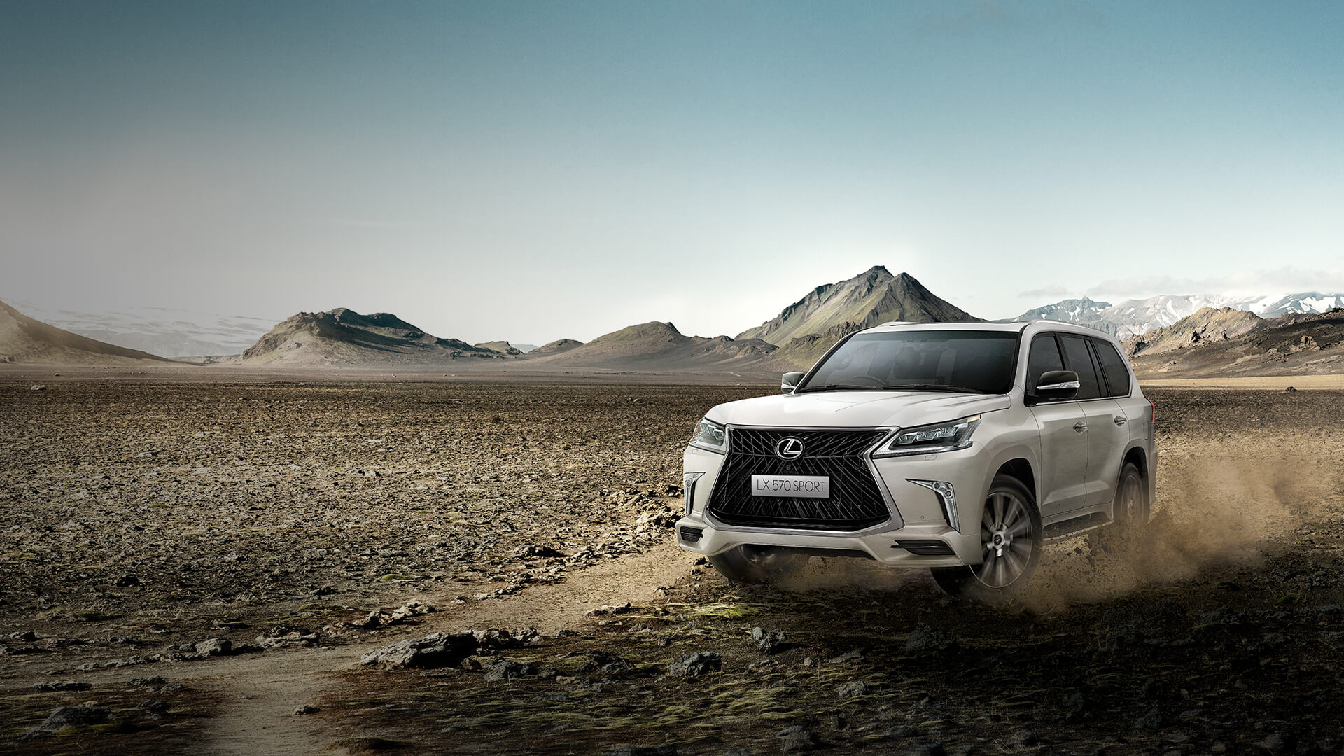 White Lexus LX being driven in sandy terrain.