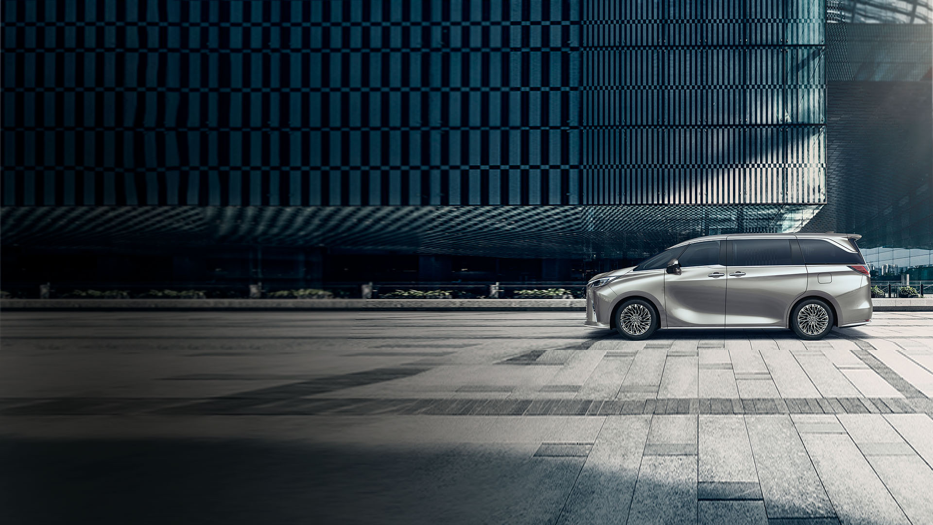 Side view of Lexus LM packed in front of a building